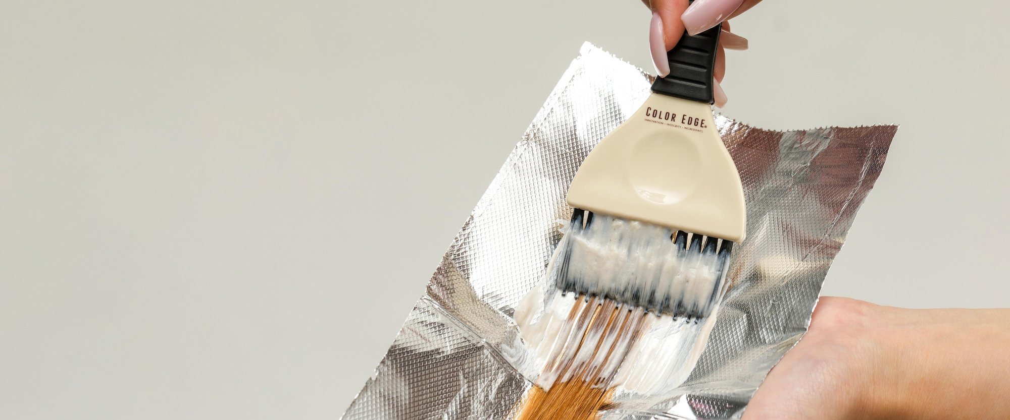 Rake Brush applying color onto hair strand