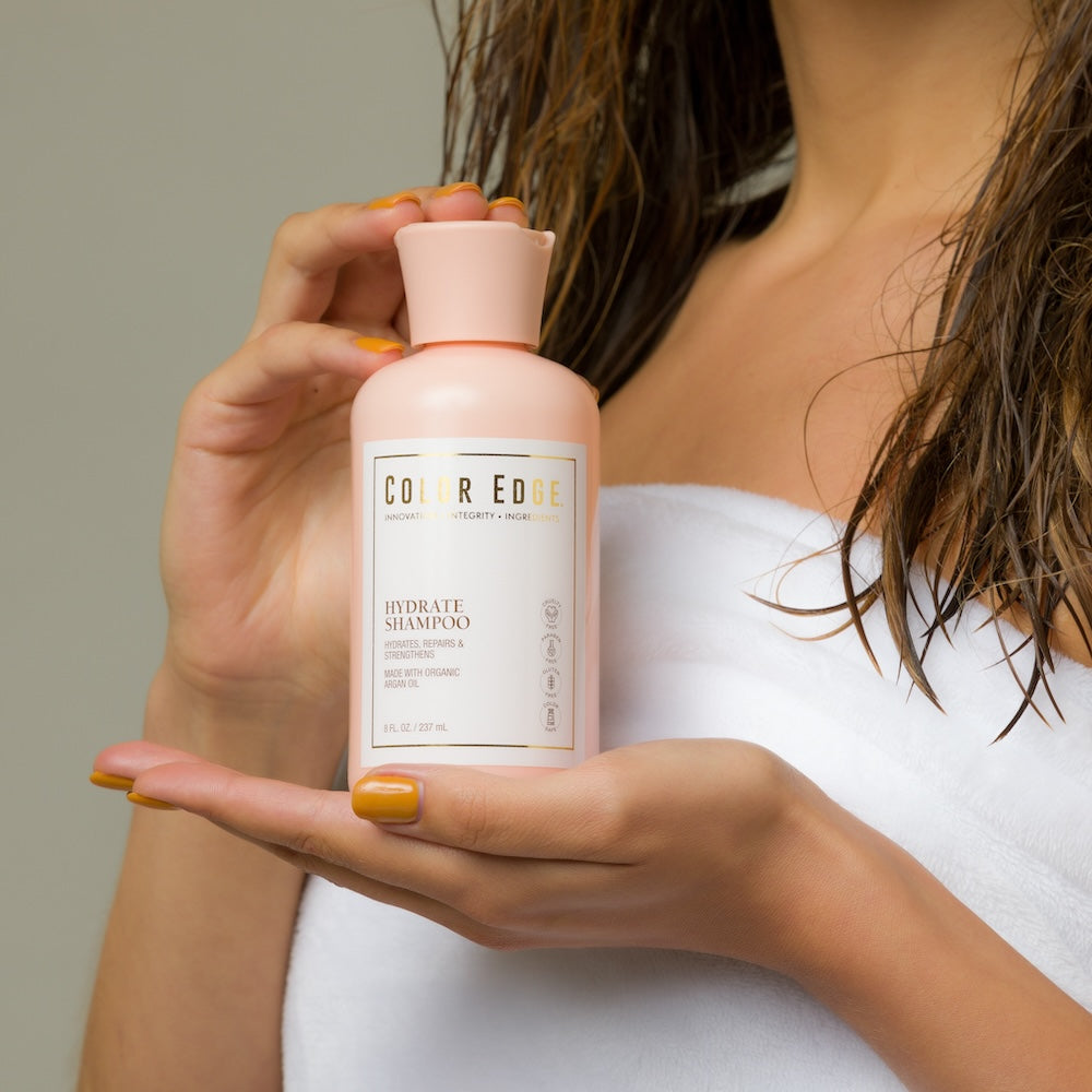 Model holding Hydrate Shampoo bottle