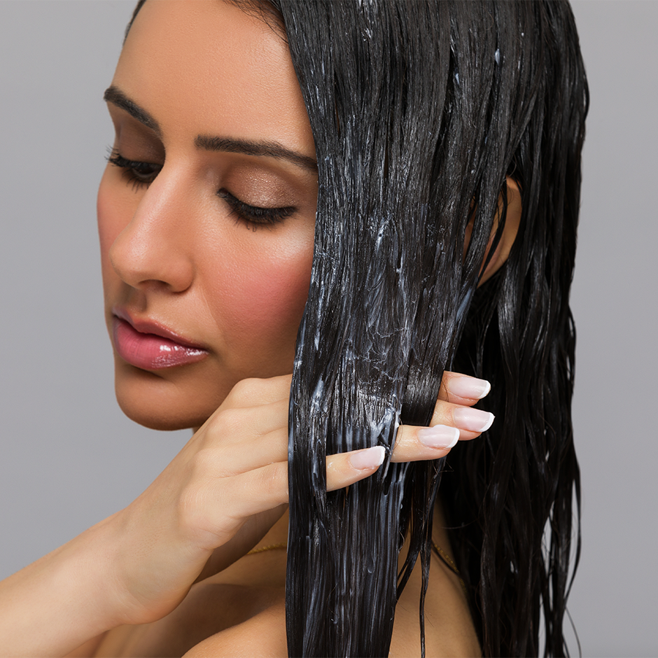 Girl using Silk Reconstructor in wet hair