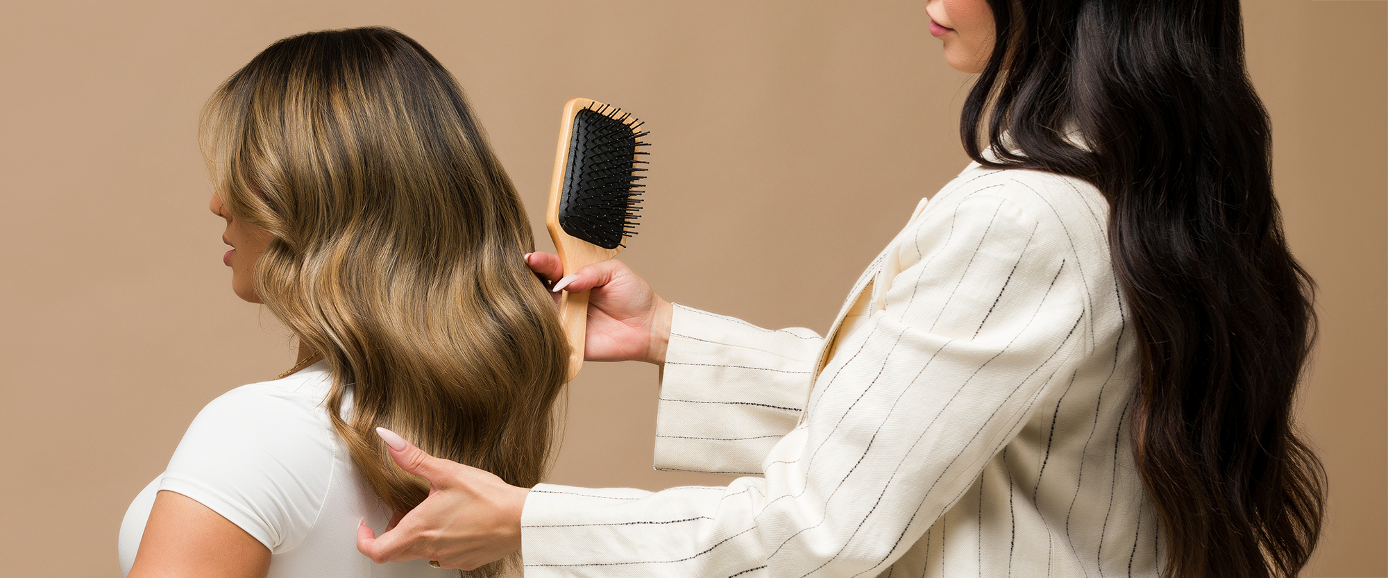 Stylist brushing clients hair