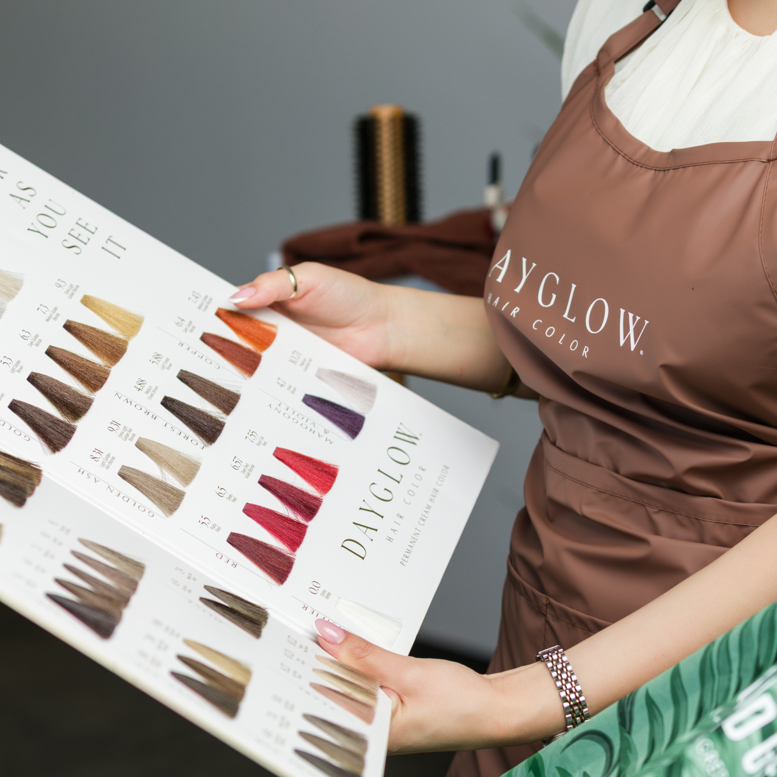 Stylist holding up the Dayglow Color Chart for client to see