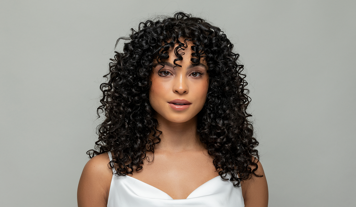 Model with curly hair after using Glazed