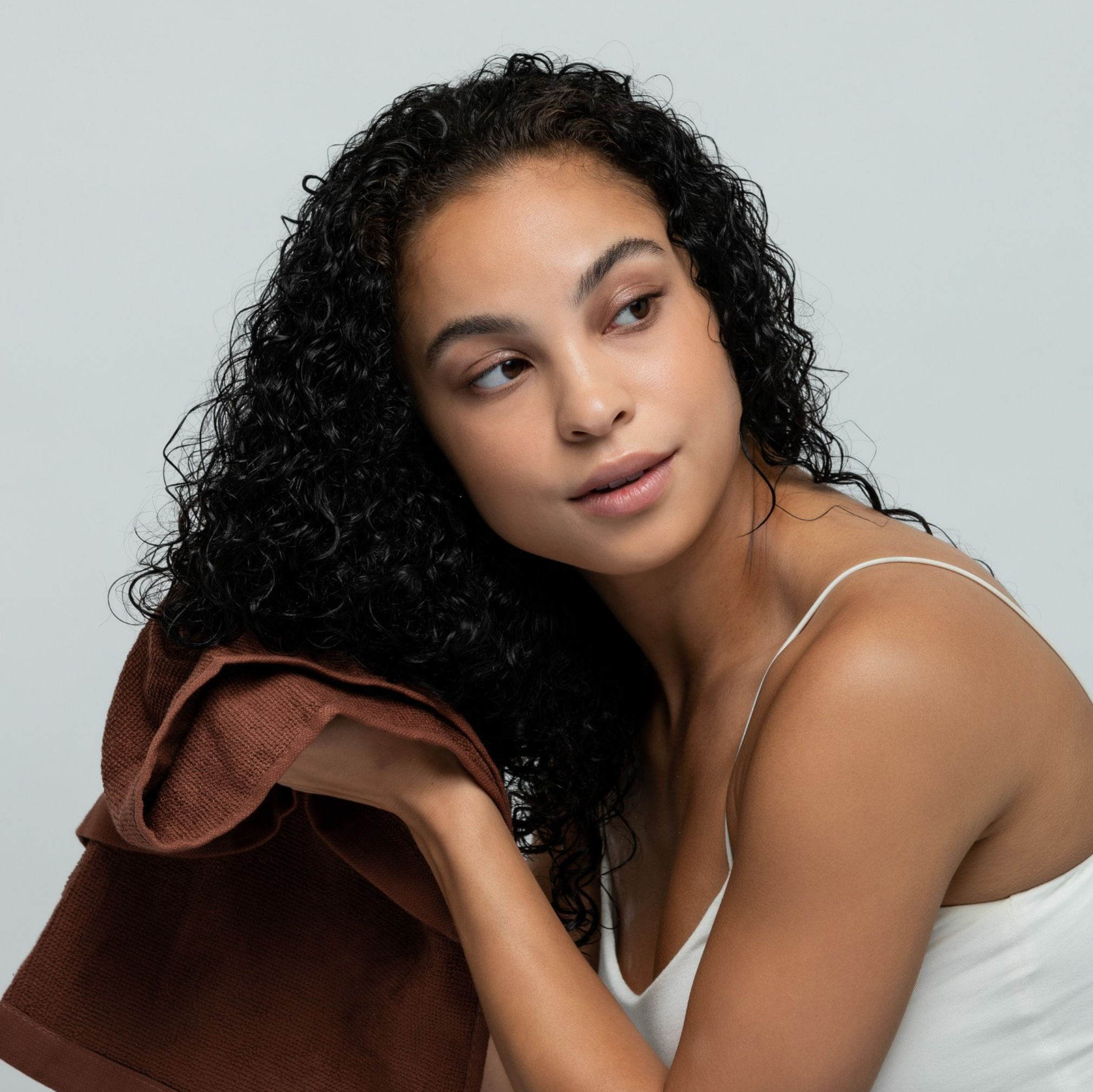 Woman using Electra Brown Hair Towel